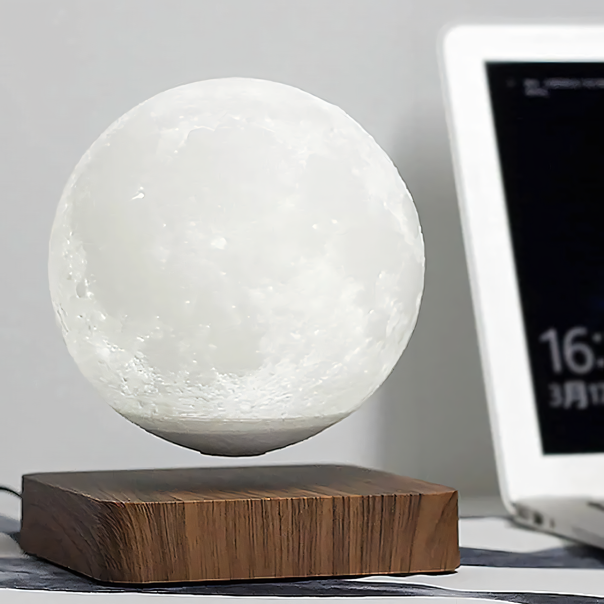 Floating moon lamp in dark room setting